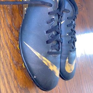 Nike gold and black cleats